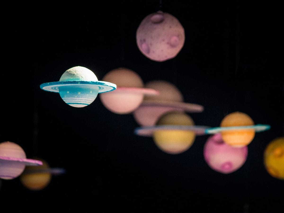 a colorful mobile of different planets 